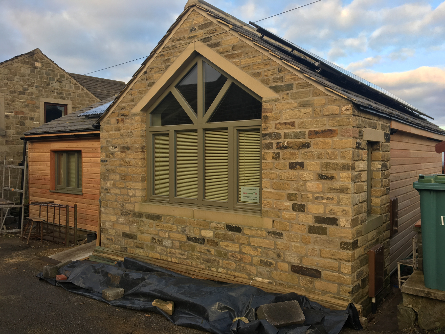 Stone faced gable with large feature window