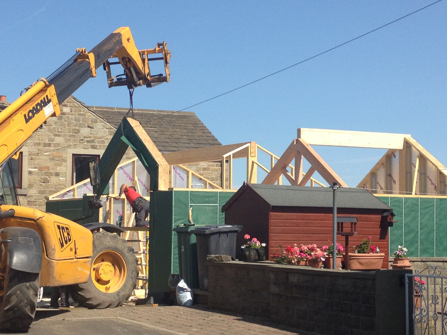 Erection of the timber frame, utilising off-site manufacture