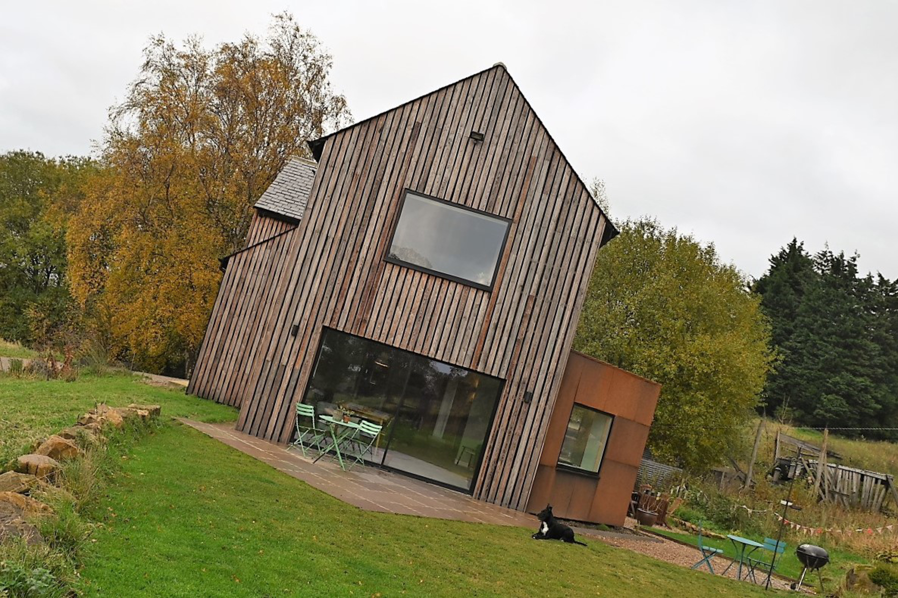 Gable end with large glazed opening to the garden and corten steel clad extension to the side